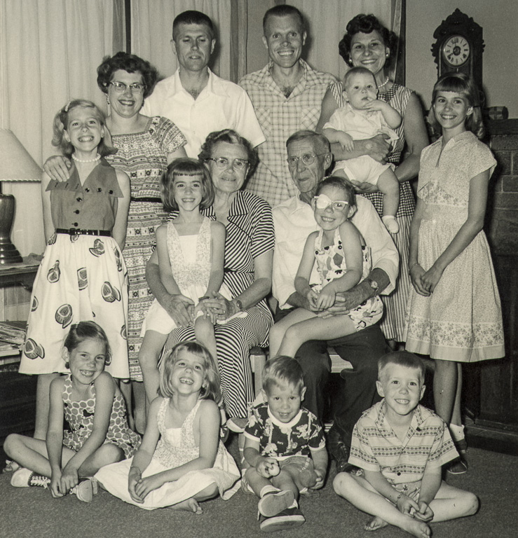 Tom and Dick Gamble and their families. Standing from left, Kathy, Barbara, Dick, Tom, Dorothy (holding Patrick), Caroline. Sitting from left, Judy, Mary, Forest, Esther. On floor, Mary, Nancy, Mike, Rick.