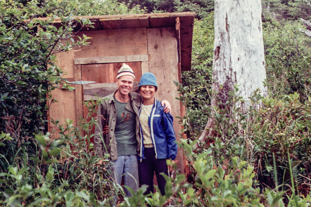 1969 — Dad and Mom. Our outhouse on our little piece of heaven at the ocean.