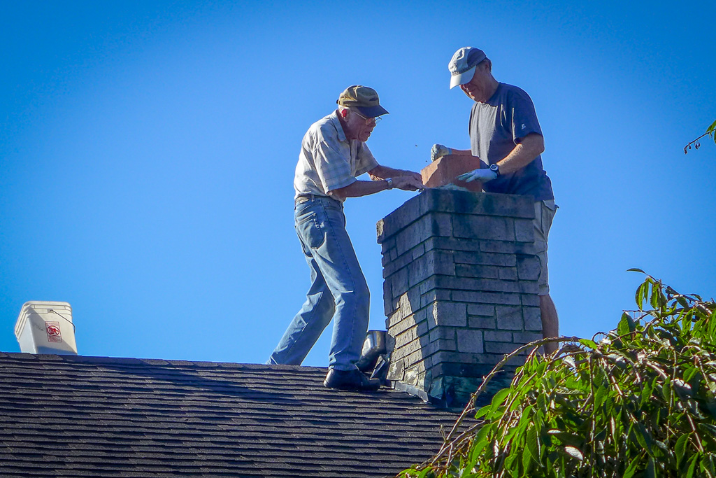 2013 — Dad, 87, with Pat on the roof repairing the chimney